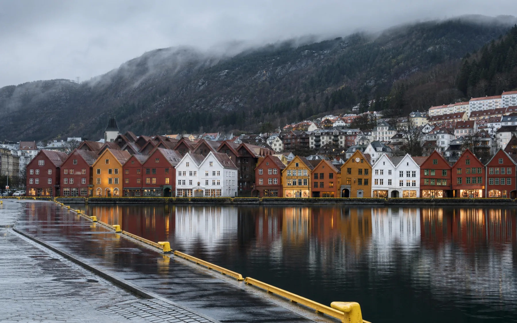 Rain-washed Bryggen waterfront beneath the mountains of Bergen